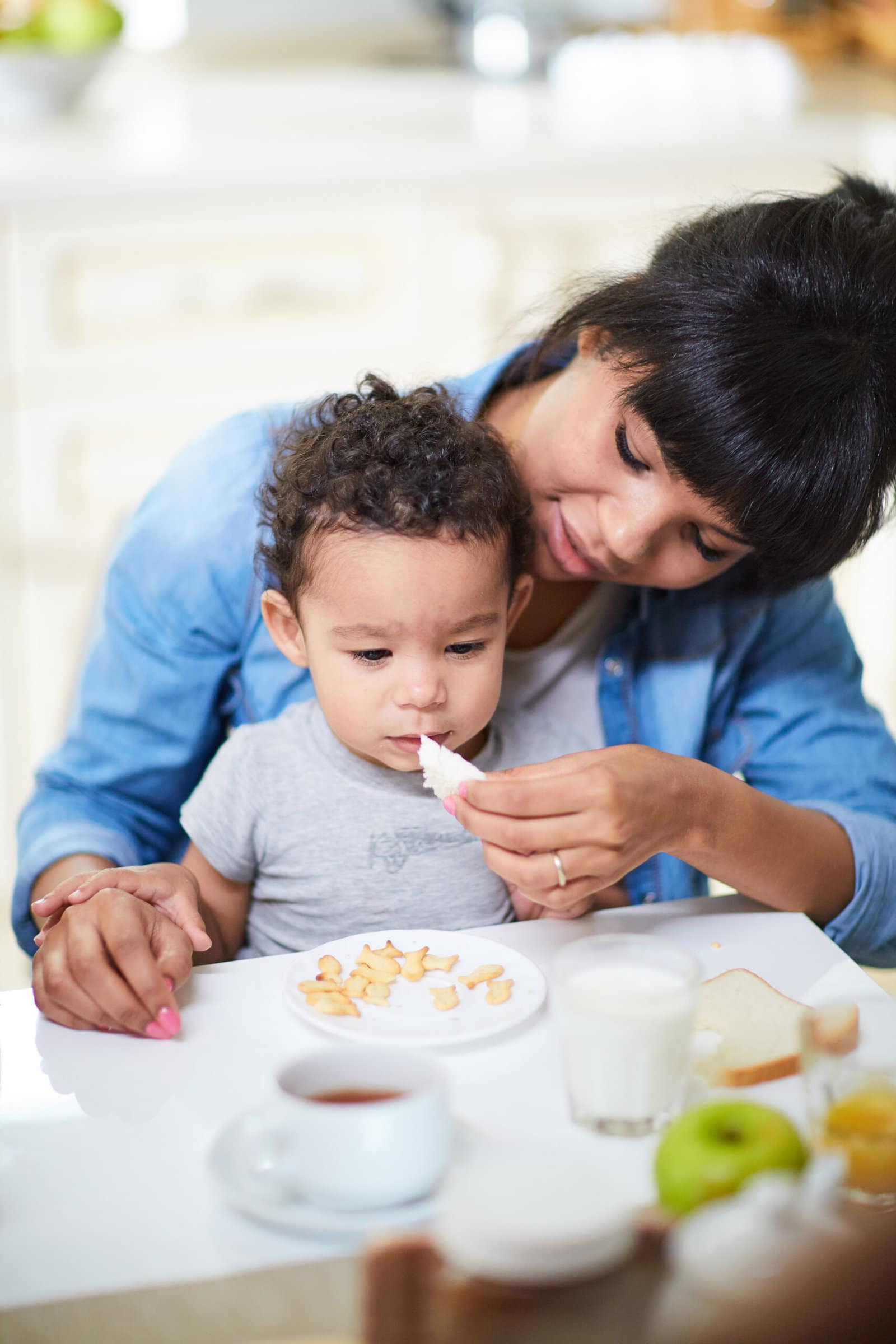 Close up of mother giving young child food